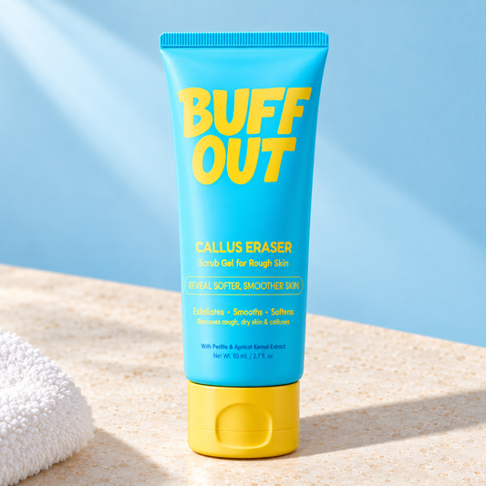 BuffOut Callus Eraser 80 mL tube on an ivory surface against a pale blue background